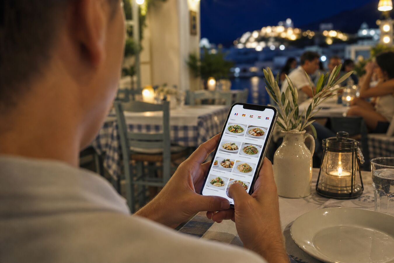 Guest at a Greek taverna using a phone to read a multilingual digital menu.